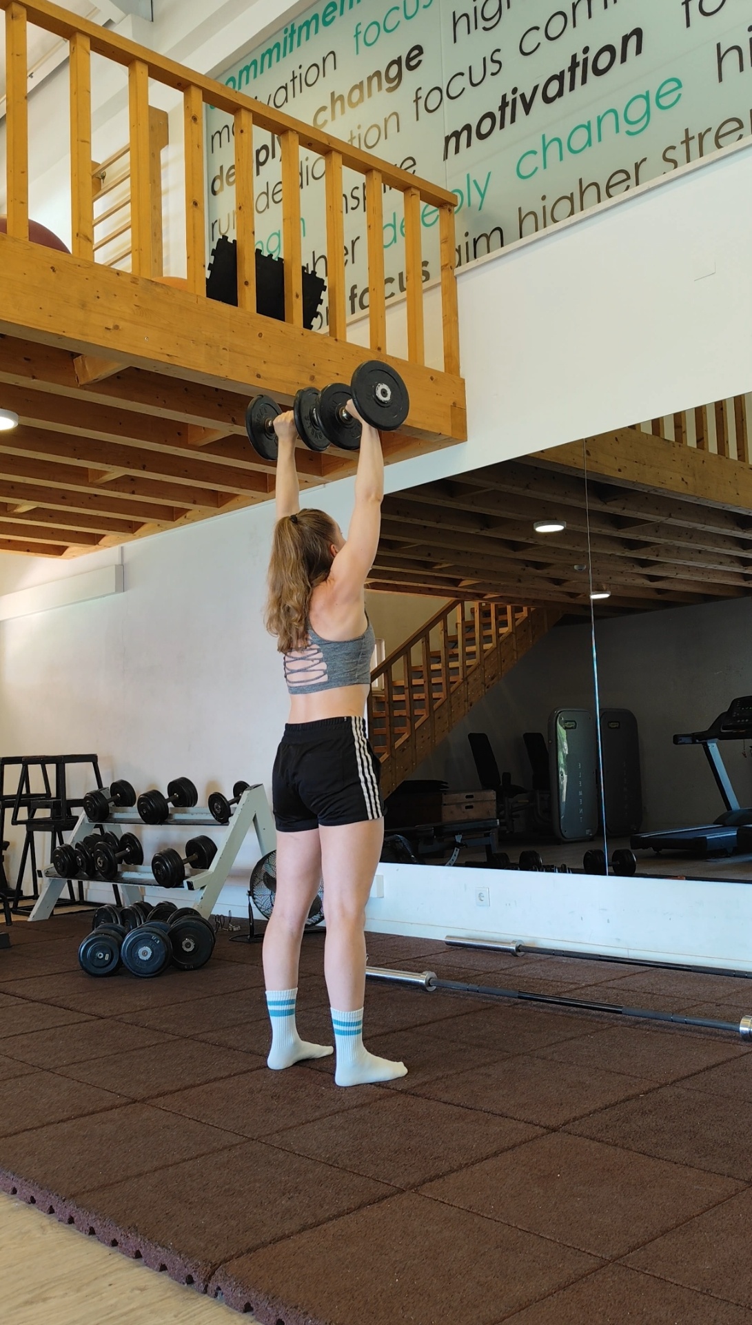 Exercise video demonstration of a dumbbell overhead press